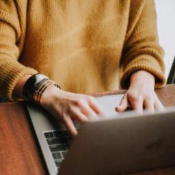 A person is typing on a laptop